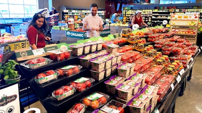 Shoppers shop at a grocery store in Glenview, Ill., Monday, July 4, 2022. Consumers spent a bit more in August than the previous month, a sign the economy is holding up even as inflation lifts prices for food, rent, and other essentials. Americans boosted their spending at stores and for services such as haircuts by 0.4% in August, after it fell 0.2% in July, the Commerce Department said Friday Sept. 30.