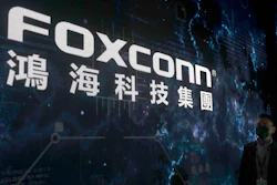 A man walks past the Foxconn logo during the 2022 Hon Hai Tech Day (HHTD 22) at the Nangang Exhibition Center in Taipei, Taiwan, Tuesday, Oct. 18, 2022.
