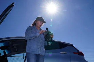 Sharon Wilson sets up a thermal imaging camera near a compressor station in Arlington, Texas, Tuesday, Oct. 18, 2022.