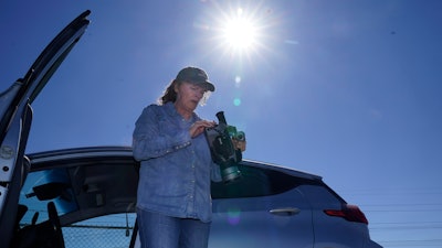 Sharon Wilson sets up a thermal imaging camera near a compressor station in Arlington, Texas, Tuesday, Oct. 18, 2022.