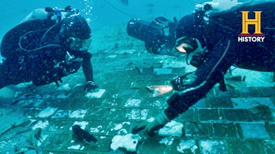 In this photo provided by the HISTORY® Channel, underwater explorer and marine biologist Mike Barnette and wreck diver Jimmy Gadomski explore a 20-foot segment of the 1986 Space Shuttle Challenger that the team discovered in the waters off the coast of Florida during the filming of The HISTORY® Channel’s new series, “The Bermuda Triangle: Into Cursed Waters,” premiering Tuesday, Nov. 22, 2022.