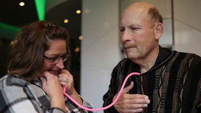 Amber Morgan, from South Bend, Ind., listens to the heartbeat of Tom Johnson, from Kankakee, at Travelodge by Wyndham Downtown Chicago, on Saturday, Nov. 19, 2022, in Chicago.