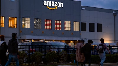 People arrive for work at an Amazon distribution center in Staten Island, New York, Oct. 25, 2021.