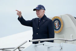 President Joe Biden gestures boarding Air Force One at Nantucket Memorial Airport in Nantucket, Mass., Sunday, Nov. 27, 2022.