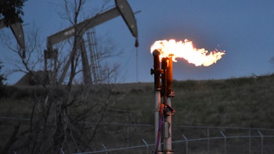 A flare to burn methane from oil production is seen on a well pad near Watford City, North Dakota, Aug. 26, 2021. The Biden administration is ramping up efforts to reduce methane emissions, targeting the oil and gas industry for its role in global warming even as President Joe Biden has pressed energy producers for more oil drilling to lower prices at the gasoline pump. Biden was set to announce a supplemental rule Friday, Nov. 11, 2022, cracking down on emissions of methane as he attends a global climate conference in Egypt.