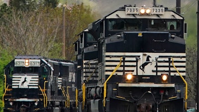 A Norfolk Southern freight train approaches a crossing in Homestead, Pa., April 27, 2022.