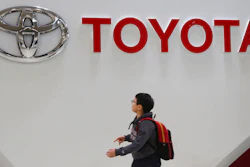A boy looks up at the logo of Toyota Motor Corp. at its gallery in Tokyo, Jan. 15, 2020. Toyota said Tuesday, Nov. 1, 2022, that its profit fell 31% in the last quarter as a shortage of computer chips offset foreign exchange gains from a weaker yen.