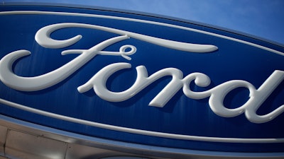 This Oct. 24, 2021 file photo shows a Ford company logo on a sign at a Ford dealership in southeast Denver.