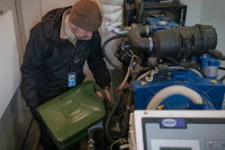Technician Oleksandr Puhlenko, of Ukrainian mobile telephone network operator Kyivstar, pours gasoline from a jerry can into a tank of a generator for phone tower on the outskirts of Kyiv, Ukraine, Wednesday, Nov. 30, 2022.