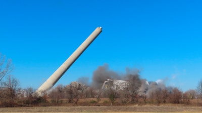 A former coal-fired power plant in Logan Township, N.J., collapses after explosives were detonated to implode it on Friday, Dec. 2, 2022.