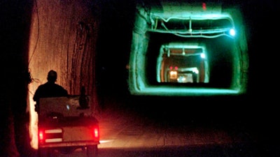 A worker drives a cart through a tunnel inside the Waste Isolation Pilot Plant No. 2, 150-feet below the surface near Carlsbad, N.M., on April 8, 1998.
