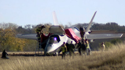 This image taken from video provided by KDFW, shows emergency personnel at the scene after a fighter jet crash landed at Naval Air Station Joint Reserve Base in Fort Worth, Texas, Thursday, Dec. 15, 2022.