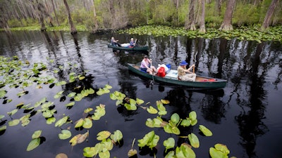 A group of visitors return to Stephen C. Foster State Park after an overnight camping trip on the Red Trail in the Okefenokee National Wildlife Refuge on April 6, 2022, in Fargo, Ga. A member of President Joe Biden's cabinet urged Georgia officials in a letter dated Nov. 22, 2022, to deny permits for a proposed mine near the edge of the famed Okefenokee Swamp and its vast wildlife refuge, saying the plan poses “unacceptable risk” to the swamp's fragile ecology.