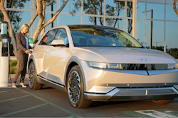 This photo provided by Hyundai shows a woman charging a 2022 Hyundai Ioniq 5 at a charging station.