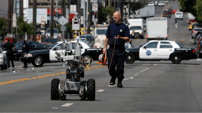A police officer uses a robot to investigate a bomb threat in San Francisco, on July 25, 2008.
