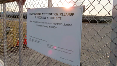 A gate at the entrance to the former Ciba Geigy chemical plant in Toms River, N.J., displays a warning sign Tuesday, Jan. 24, 2023, regarding the contaminated area, which is on the Superfund list of the nation's worst toxic waste sites.
