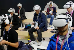 Attendees wear VR headsets while previewing the Caliverse Hyper-Realistic Metaverse experience at the Lotte booth during the CES tech show Friday, Jan. 6, 2023, in Las Vegas.