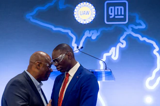 UAW President Ray Curry, left, speaks privately with Lt. Gov. Garlin Gilchrist after a news conference on Friday, Jan. 20, 2023.