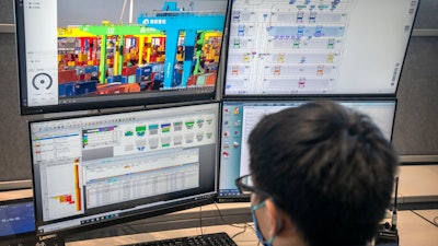 A worker uses a computer terminal to monitor remote operations at a container port in Tianjin, China, on Jan. 16, 2023.