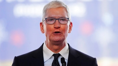 Apple CEO Tim Cook speaks in front of the new Taiwan Semiconductor Manufacturing Company facility under construction in Phoenix, Tuesday, Dec. 6, 2022. Cook will take a more than 40% pay cut this year from a year earlier as the company adjusts how it calculates his compensation. Apple Inc. said in a regulatory filing that Cook’s target total compensation is $49 million for 2023.