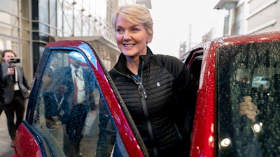 Energy Secretary Jennifer Granholm gets into the passenger seat after test driving a Ford F-150 Lighting all electric vehicle during a visit to the Washington Auto Show in Washington, Wednesday, Jan. 25, 2023.