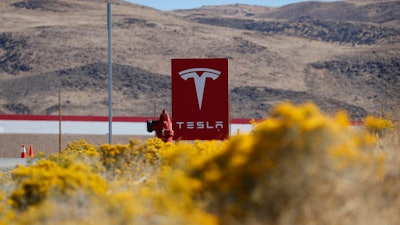 In this Oct. 13, 2018, file photo, a sign marks the entrance to the Tesla Gigafactory in Sparks, Nev.