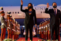 Vice President Kamala Harris and Guatemala's Minister of Foreign Affairs Pedro Brolo wave at her arrival ceremony in Guatemala City, Sunday, June 6, 2021, at the Guatemalan Air Force Central Command.