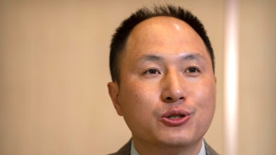 Chinese scientist He Jiankui speaks at a brief press conference in Beijing, Tuesday, Feb. 21, 2023.