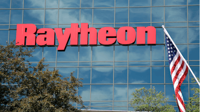 An American flag flies in front of the façade of Raytheon's Integrated Defense Systems facility, in Woburn, Mass on June 10, 2019.