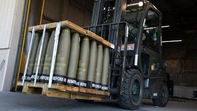 Airmen with the 436th Aerial Port Squadron use a forklift to move 155 mm shells ultimately bound for Ukraine, April 29, 2022, at Dover Air Force Base, Del.