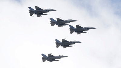 Taiwan's F-16 fighter jets fly in close formation over President Office during National Day celebrations in front of the Presidential Building in Taipei, Taiwan, Oct. 10, 2021.