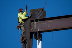 An ironworker guides a beam during construction of a municipal building in Norristown, Pa., Wednesday, Feb. 15, 2023.