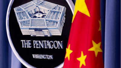 China's national flag is displayed next to the Pentagon logo at the Pentagon, Monday, May 7, 2012.