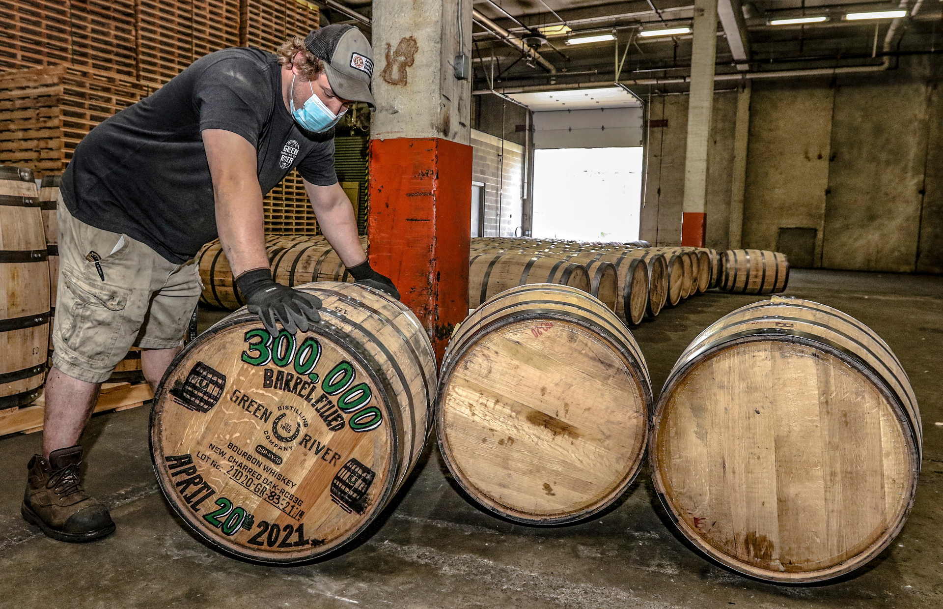 Green River Distilling Co. employee Coleman Savage looks over the 300,000th barrel of bourbon filled at the distillery inside the new-fill warehouse at the plant on April 20, 2021, in Owensboro, Ky.