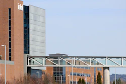 Workers walk on a skybridge to and from a large Intel facility in Hillsboro, Ore., on March 17, 2023.