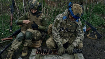 Ukrainian soldiers prepare their ammunition at the frontline positions near Vuhledar, Donetsk region, Ukraine, Monday, May 1, 2023.