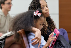 Philana Holmes and her daughter Olivia Caraballo, 7 listen to the final witness in their case at the Broward County Courthouse in Fort Lauderdale on Wednesday May 10, 2023.