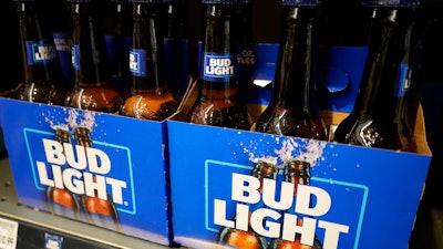 Bottles of Bud Light beer sit on a shelf at a grocery store on April 25, 2023, in Glenview, Ill. Bud Light's parent company said Thursday, May 4, that it will triple its marketing spending in the U.S. this summer as it tries to boost sales.
