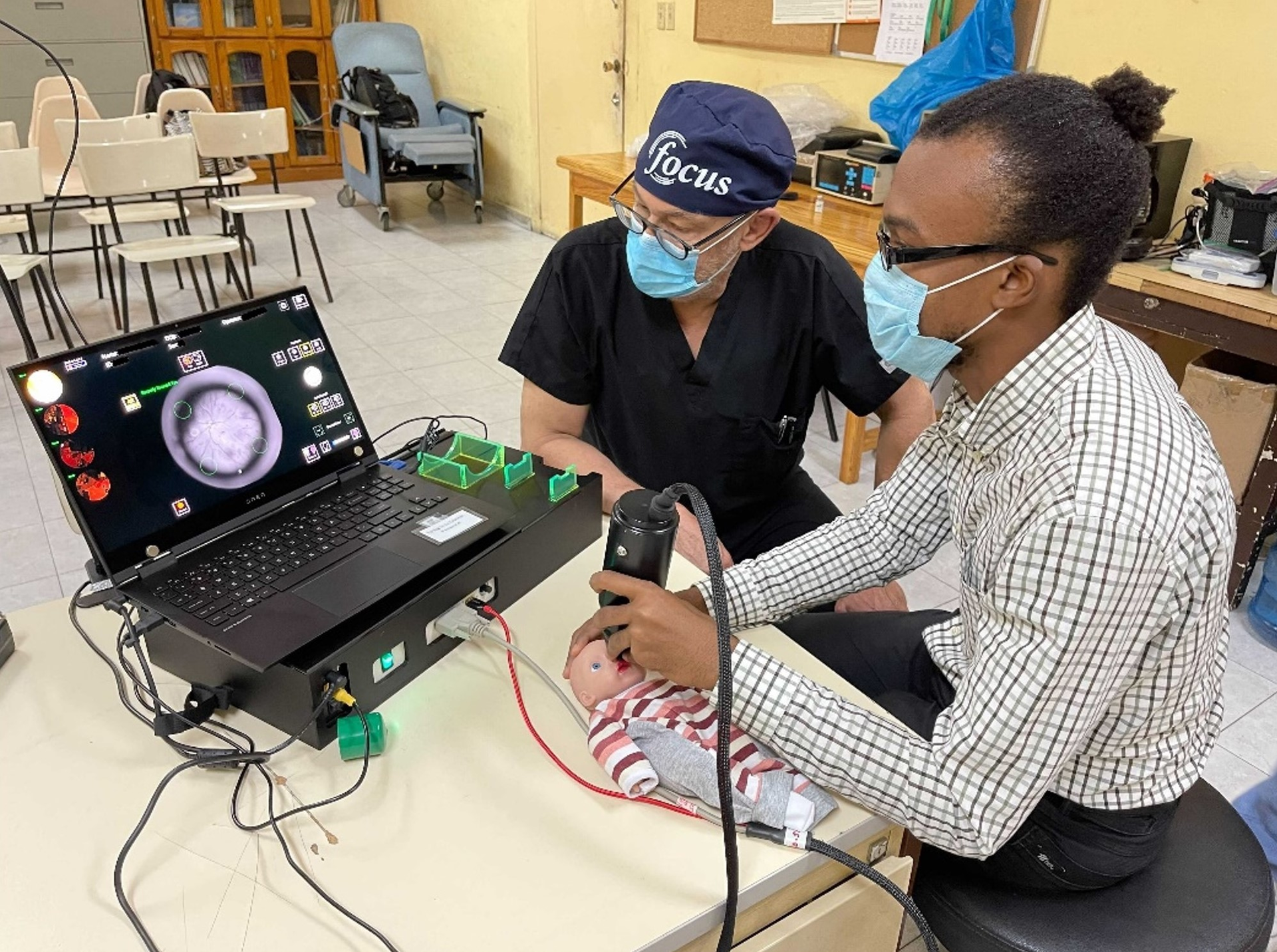 Doctors practicing imaging using the model eye on-site in Haiti.