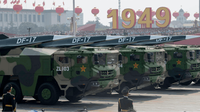 Military vehicles carry an earlier version of China’s hypersonic missile during a 2019 parade.