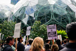 Amazon corporate workers hold picket signs in front of the Amazon Spheres, Seattle, May 31, 2023.