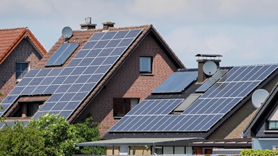 Rooftops on private houses are covered by solar panels to produce renewable electricity in Duelmen, Germany, Tuesday, May 3, 2022.