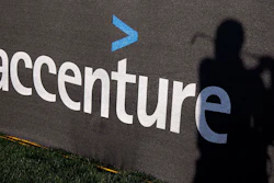 The Accenture logo is displayed on a scrim as Denmark's Thomas Bjorn's shadow is cast onto it while he practices for the Match Play Championship, Feb. 20, 2012, in Marana, Ariz.