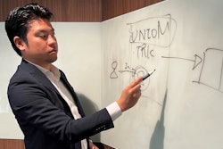 Yoshihito Hasegawa, who heads Tokyo-based TRK that runs a job-quitting service called Guardian, shows a diagram to explain what his service does at his office in Tokyo on June 21, 2023.