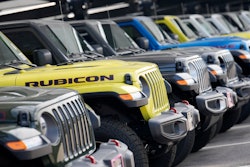 Unsold 2023 Gladiator pickup trucks sit in a long row at a Jeep dealership Sunday, June 18, 2023, in Englewood, Colo.