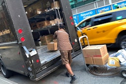 A United Parcel Service driver loads his truck adjacent to a UPS Store in New York, May 11, 2023.