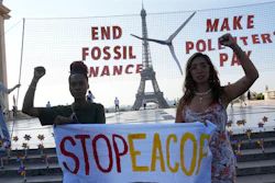 Climate activists Patience Nabukalu, of Uganda, left, and Mitzi Jonelle Tan, of the Philippines, participate in a demonstration ahead of the Global Climate Finance Summit, Wednesday, June 21, 2023 in Paris. The aim of a two-day climate and finance summit in Paris that ends Friday, June 23, was to set up concrete measures to help poor and developing countries better tackle issues like poverty and climate change.