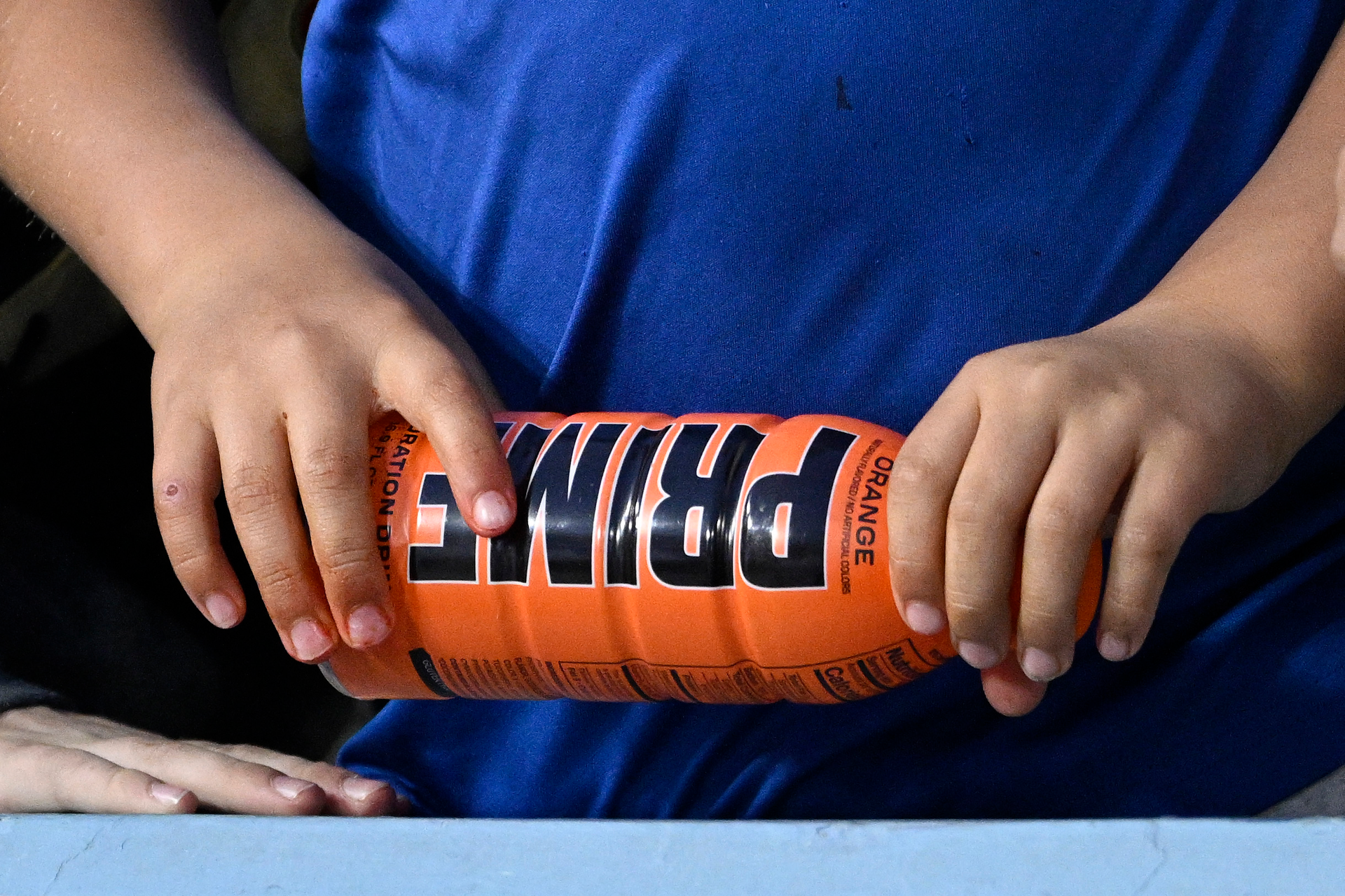 A child holds a PRIME hydration drink prior to a baseball game between the Los Angeles Dodgers and the Arizona Diamondbacks, March 31, 2023, in Los Angeles.