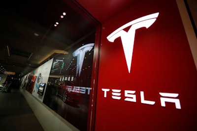 A sign bearing the company logo outside a Tesla store in Cherry Creek Mall in Denver is seen here on Feb. 9, 2019.