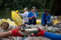 Volunteers sort collected rubbish at a campsite near the Tisza River, Aug. 1, 2023.